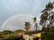 .A colorful rainbow in the sky over village houses in the late afternoon