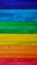 Colorful rainbow spectrum wooden rough paint texture background.