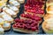 Colorful raspberry cream cheese tart and fruit tart in bakery