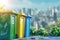 Colorful recycling bins against a cityscape background.