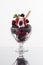 Colorful red berrie cup with chocolate ice and whipped cream