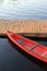 Colorful red kayak tied to dock