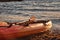 Colorful red and orange canoe next to the water