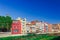 Colorful red, orange and yellow houses and bridge through river Onyar in Girona, Catalonia, Spain. Scenic ancient town. Famous