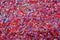 Colorful red, pink, yellow, and purple stone mosaic tiles on the wall