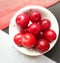 Colorful Red plums placed in bowl placed in colors backgrounds and reduce the risk of cancer heart disease and diabetes