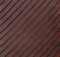 Colorful red thread. Oblique lines from corner to corner, on a black isolated background. Texture, abstract background