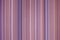 colorful red toned fabric background with soft faded rainbow-colored vertical stripes