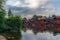 The colorful red wooden warehouses of Porvoo in Finland reflecting in the river at sunset during a warm summer evening - 3