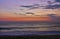 Colorful reddish sky over the horizon with layer of sand in foreground