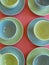 Colorful retro teacups in geometric pattern of circles and curves.