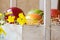 Colorful ripe red yellow apples, pears in vintage wood box, summer flower, fruits in basket, outdoors, garden
