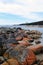 Colorful rocks at Binalong Bay in NE Tasmania
