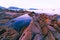 Colorful rocks and waves crashing on seashore Large colorful stones