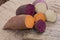 Colorful root vegetables pink, purple and orange organic sweet potatos