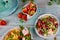 Colorful rotini pasta with healthy spring salad and fresh strawberries