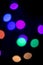 Colorful round bokeh lights at night with a black background