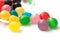 colorful round candies falling from glass container o