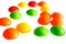 Colorful round candy pieces on white background