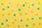 Colorful round sprinkles over yellow background, decoration for festive Valentines day, birthday, holiday and party time