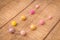 Colorful round wood and wool felt beads necklace handmade with pink, golden and yellow color beads on a wood table