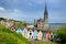 Colorful row houses with St. Colman`s Cathedral in background in the port town of Cobh, County Cork, Ireland