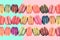 Colorful rows macarons on vintage pastel background