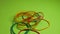 Colorful rubber band on a green background
