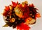 Colorful and rustic background with red pumpkin, peppers, chestnut and fall leaves on the plate