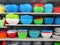 Colorful salad bowls on shelves.