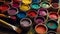 Colorful sample paint pots arranged around an overhead DIY paint brush, inviting artistic exploration