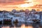 Colorful Scandinavian village in snow on coastline at morning