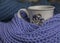 Colorful scarves, violet and blue, and a cup of tea.