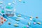 Colorful scattered tablets, water glass, blister with medical pills, multivitamins