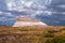 Colorful scene with sunlit butte against a dramatic sky at the Petrified Forest