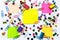 Colorful school and office supplies paper clips, pins, yellow notes, stickers on white background