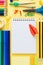 Colorful school stationery collection on yellow background