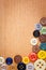 Colorful sewing buttons on a wooden background