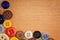 Colorful sewing buttons on a wooden background