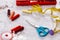 Colorful sewing and tailoring tools and items on light background