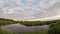 Colorful sheep clouds over a wetland