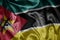 colorful shining big national flag of mozambique on a silky texture