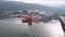 Colorful ships and boats moor at pier against fish storage