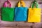 Colorful shopping bags hanging on wooden wall