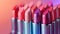 A colorful shot of a collection of unbranded lipsticks arranged in a gradient pattern