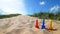 Colorful shovels in the beach sand with the blue sky in the background