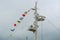 Colorful signal nautical flags against cloudy sky.