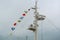 Colorful signal nautical flags against cloudy sky.