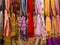 Colorful silk scarvers hanging on market stall, India