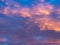 A colorful sky full of pink, blue and orange colors. Contrasting clouds shimmering in different colors at sunset